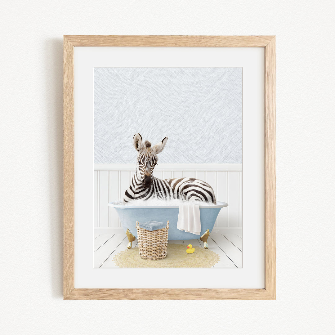 A zebra is sitting in a blue bathtub filled with water, surrounded by rubber ducks and a basket.