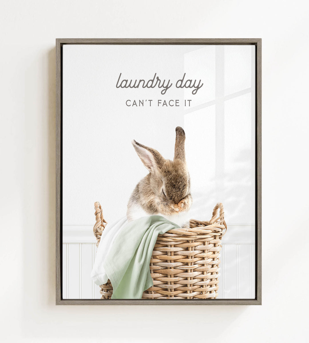 A cute rabbit sitting in a wicker basket, with the text "laundry day can't face it" above the image.