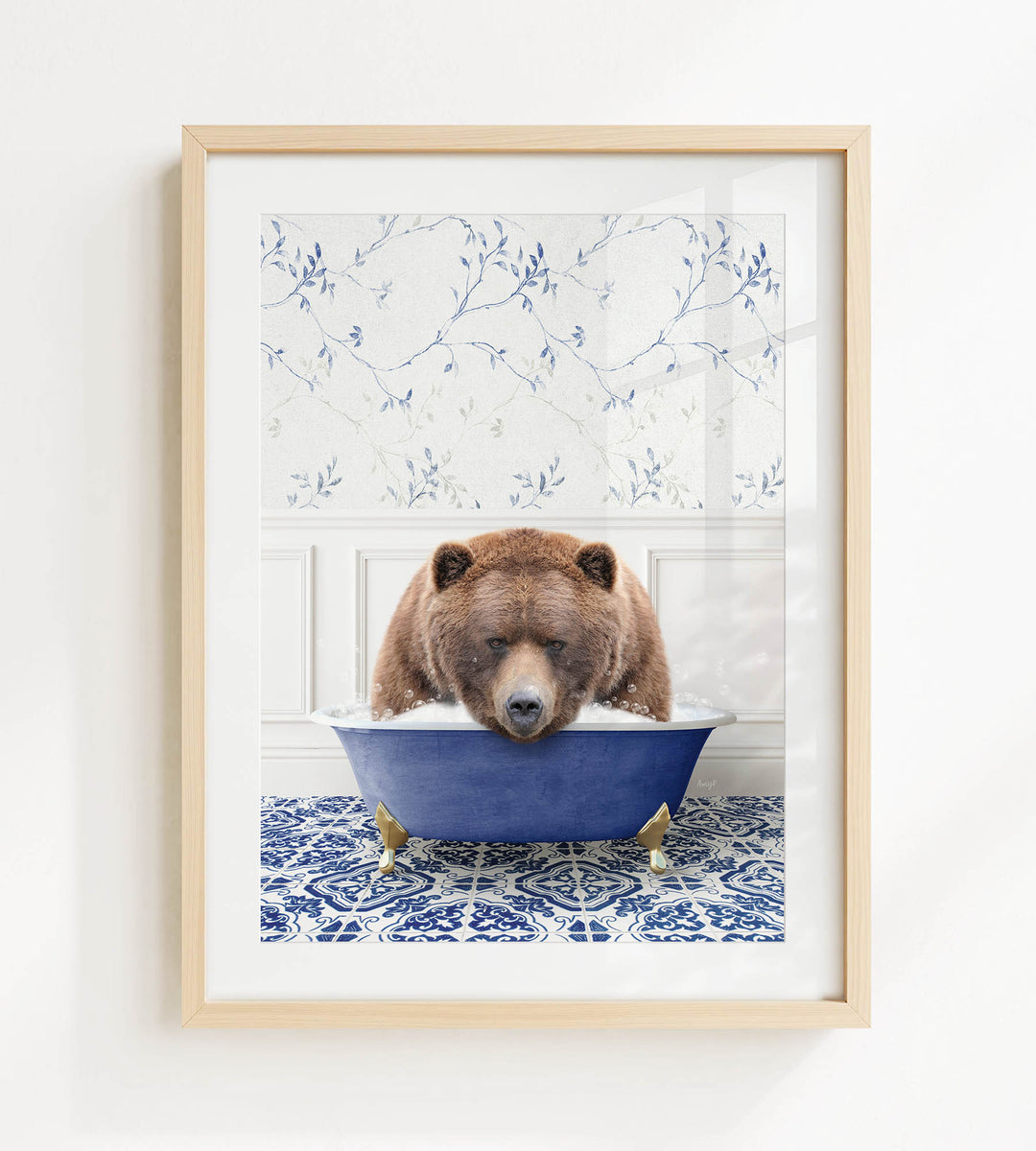 A brown bear is sitting in a blue bathtub, surrounded by a patterned tile floor and a white wall with blue floral wallpaper.