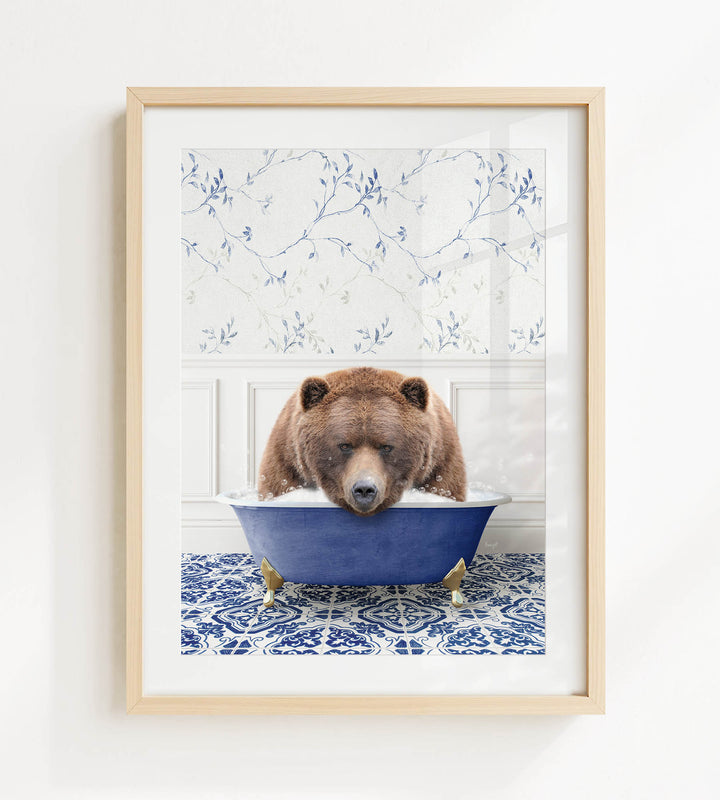 A brown bear is sitting in a blue bathtub, surrounded by a patterned tile floor and a white wall with blue floral wallpaper.