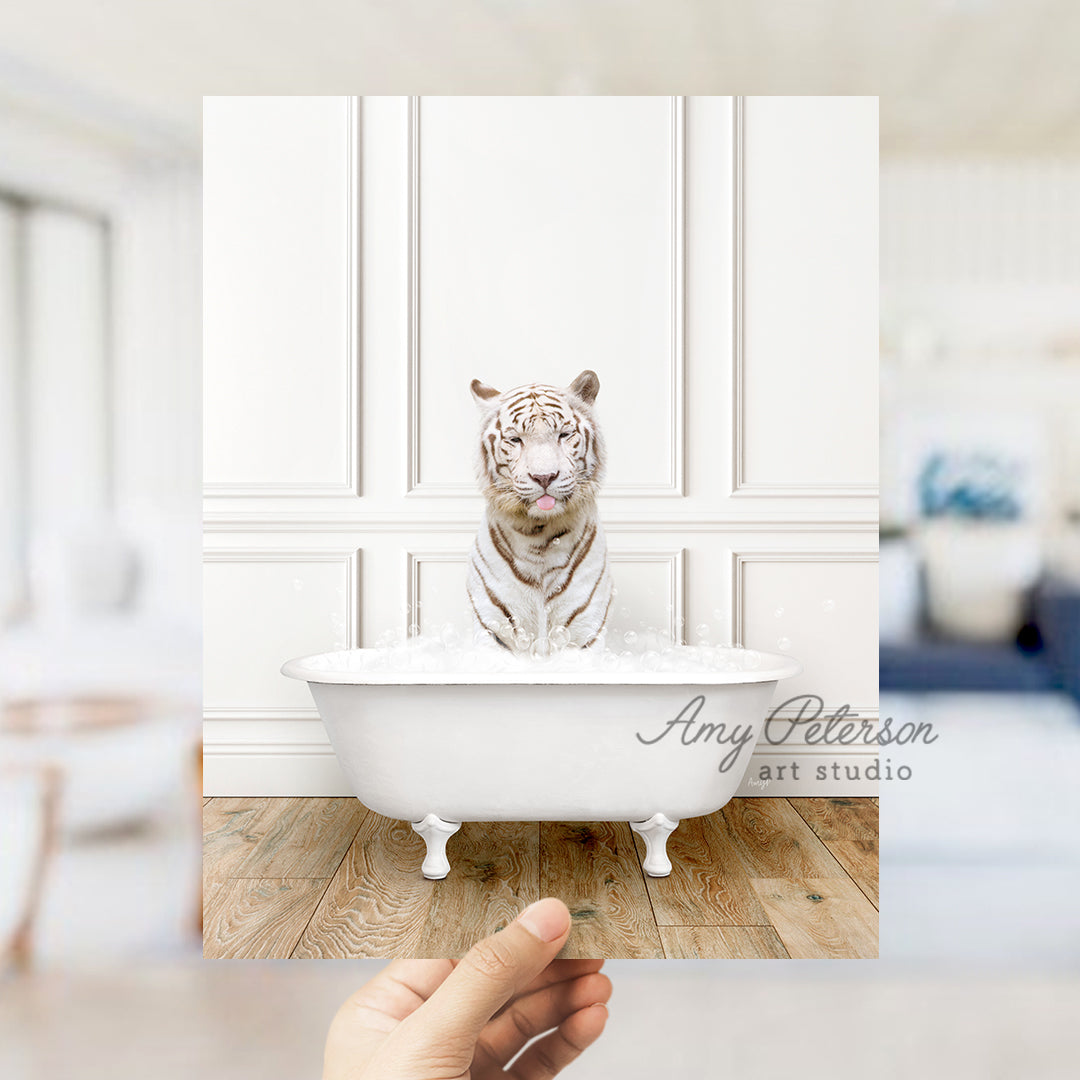 a hand holding a photo of a white tiger in a bathtub