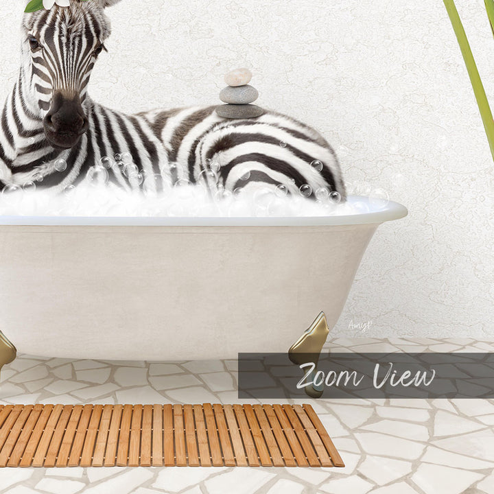 A zebra is sitting in a bathtub filled with water, surrounded by a wooden mat and a stone stack.