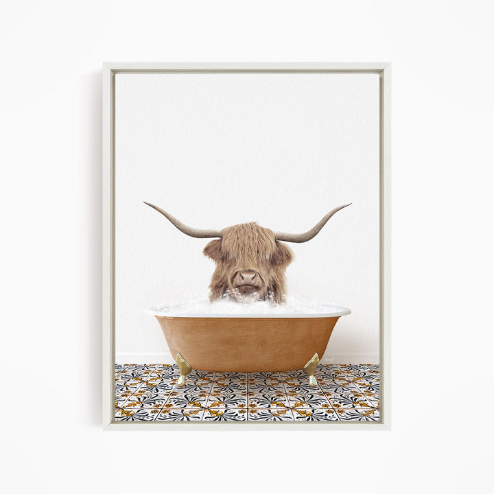 A Highland cow with large horns is sitting in a bathtub filled with water, creating a whimsical and playful scene.