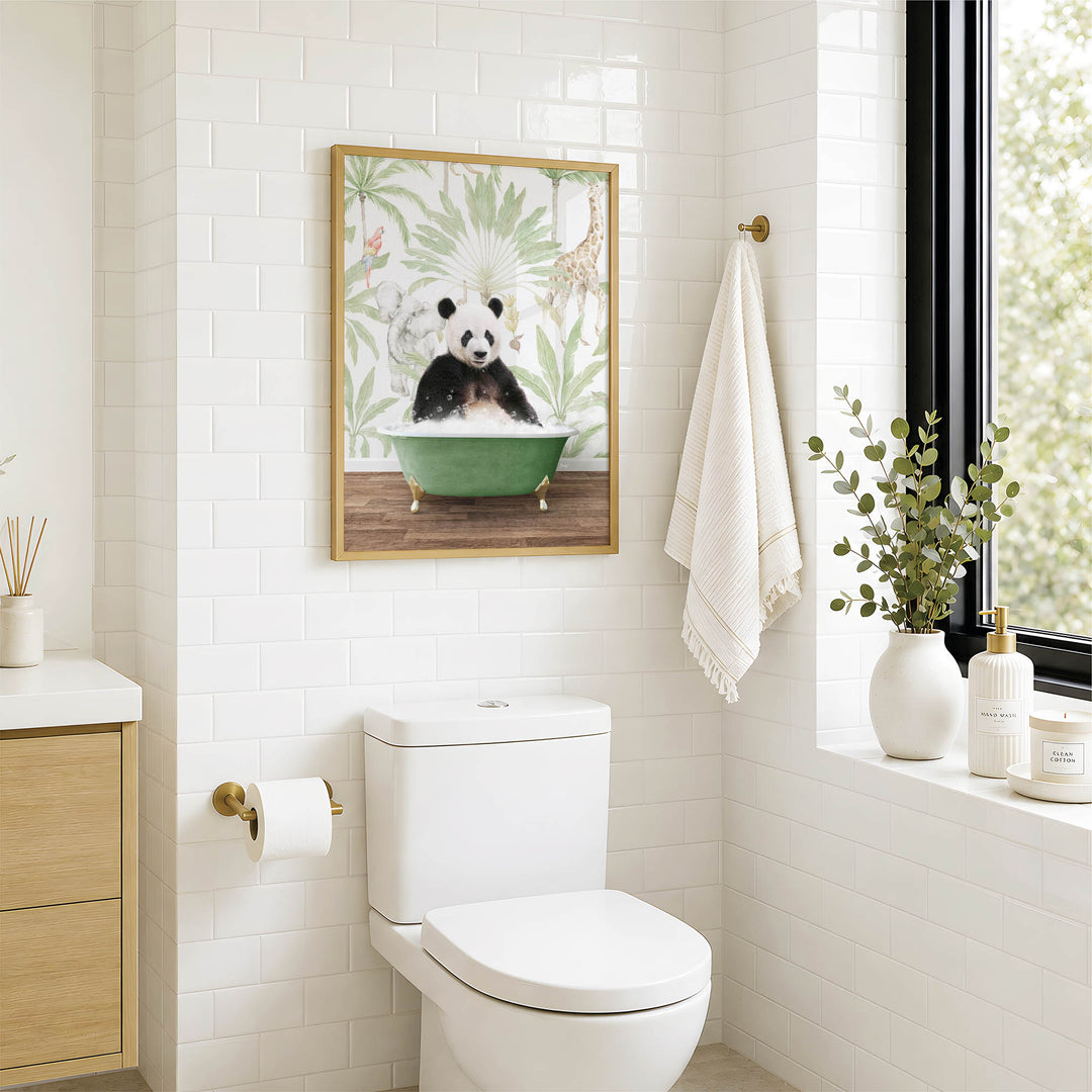 A bathroom with a white toilet, a framed picture of a panda sitting in a bathtub, and a window with greenery outside.