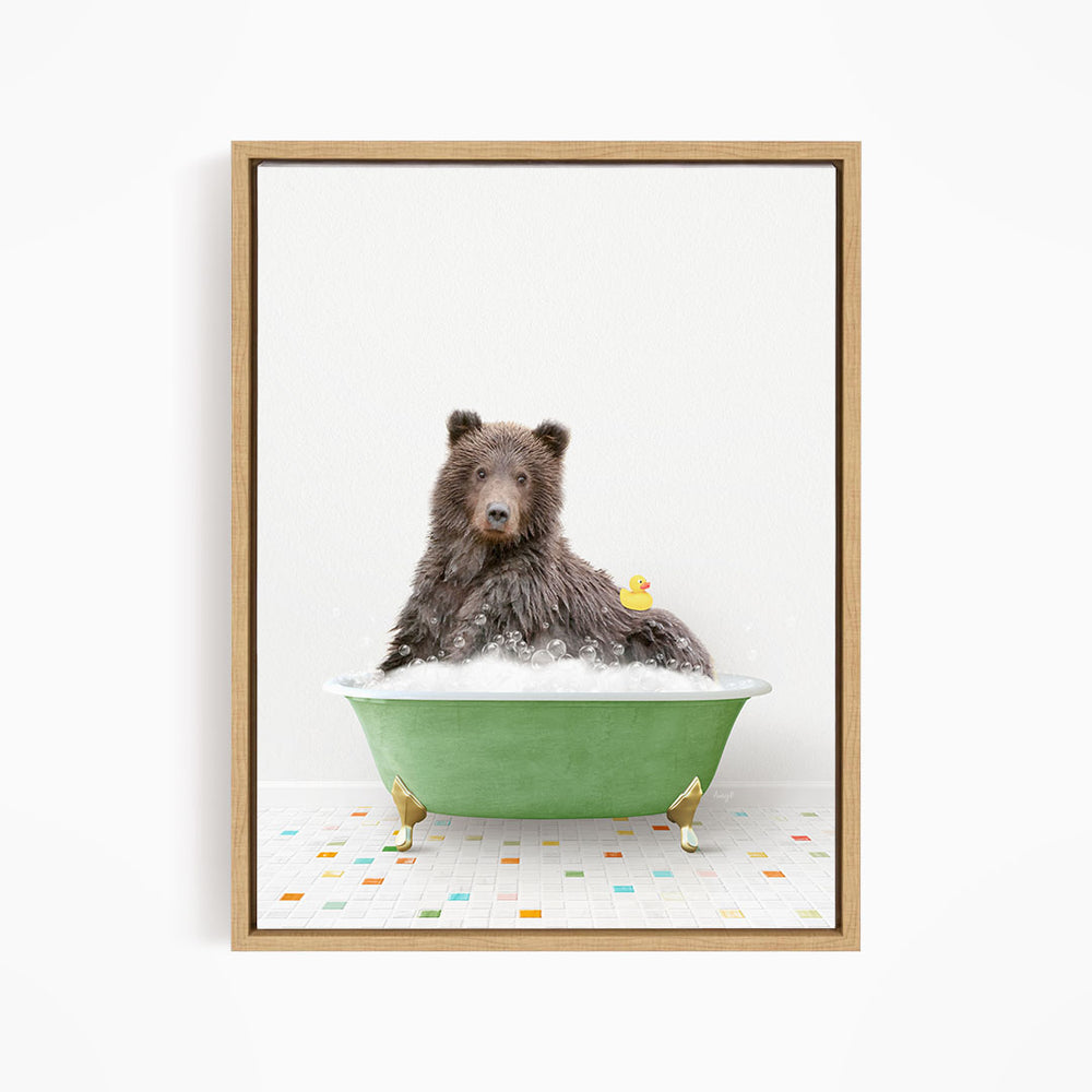 A brown bear sitting in a green bathtub, with a yellow rubber duck floating on the water.