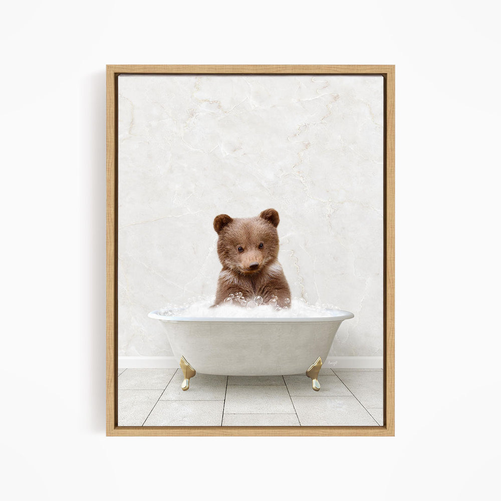 A brown bear sitting in a white bathtub filled with water, looking directly at the camera.