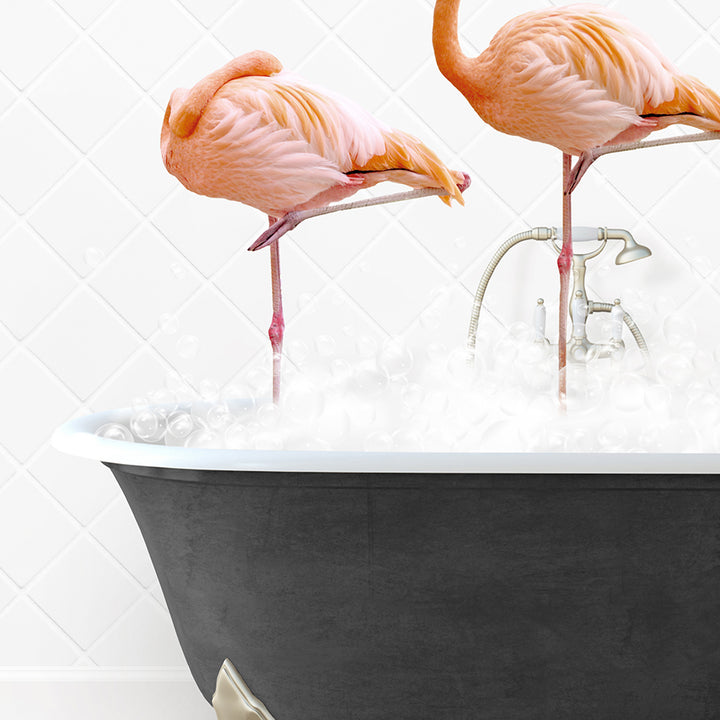 two pink flamingos standing in a bathtub filled with water