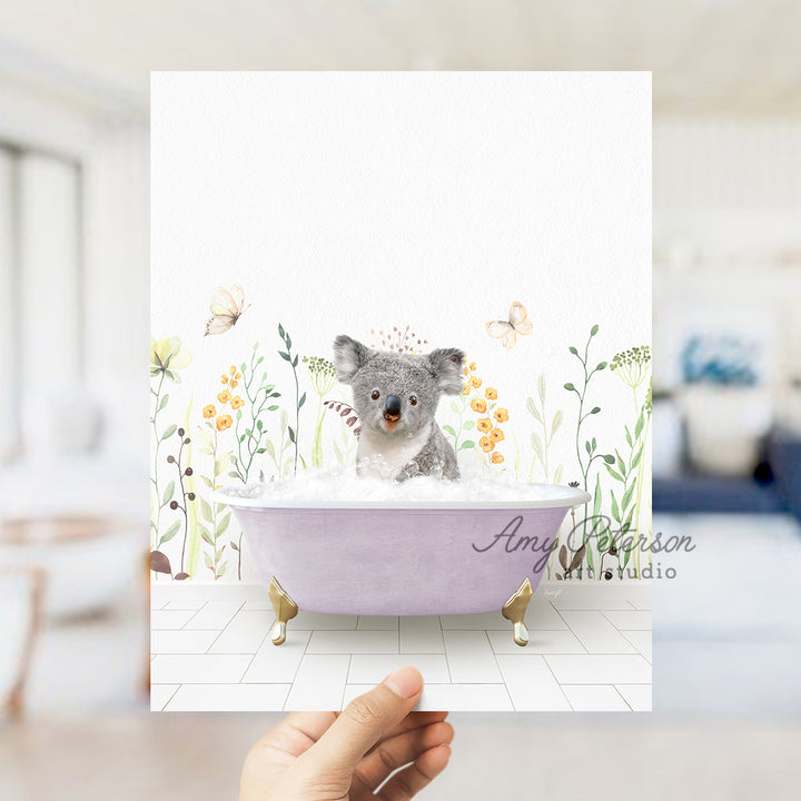 a person holding a card with a picture of a koala in a bathtub