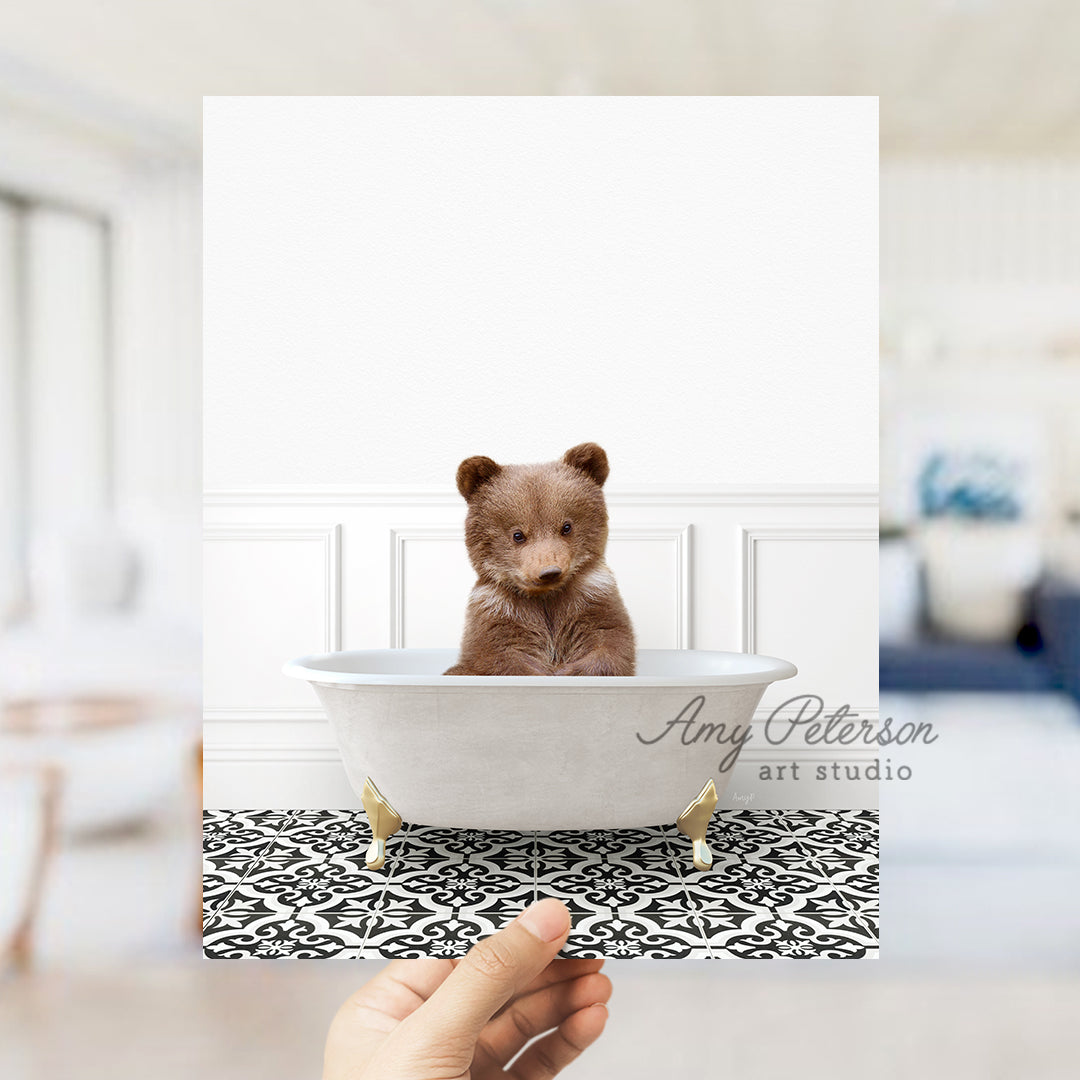 a person holding up a polaroid picture of a teddy bear in a bathtub