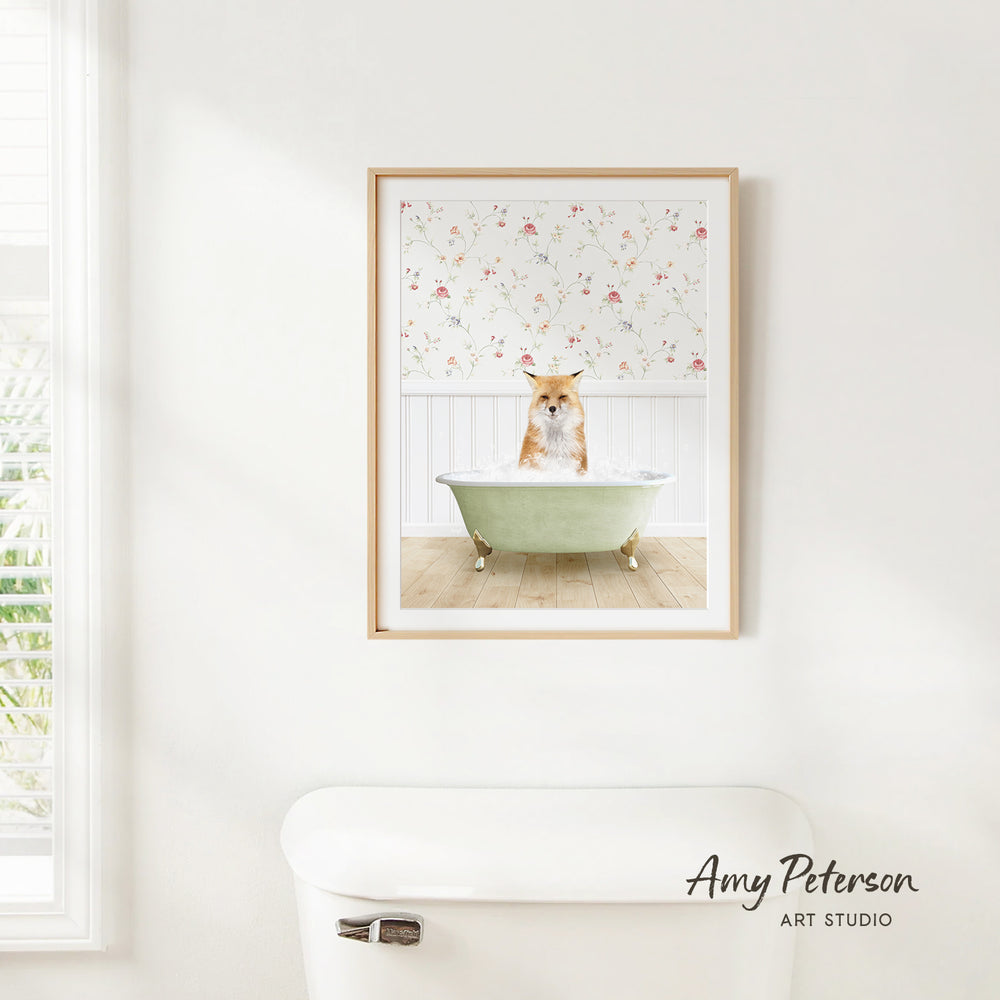 A framed image of a cat sitting in a bathtub, with a floral pattern on the wall behind it.