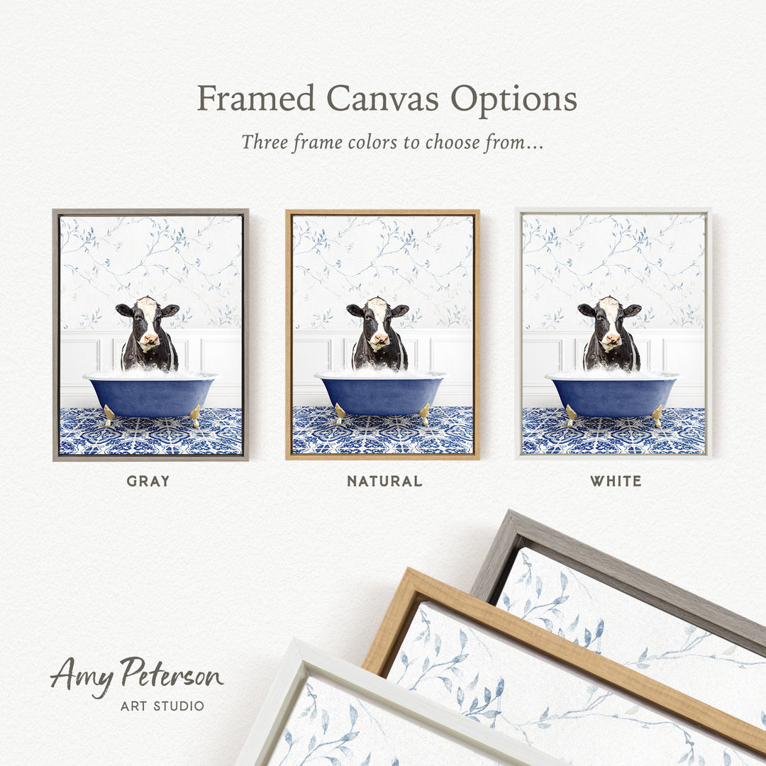 three framed canvas options featuring a cow sitting in a bathtub, each with a different frame color: gray, natural, and white.