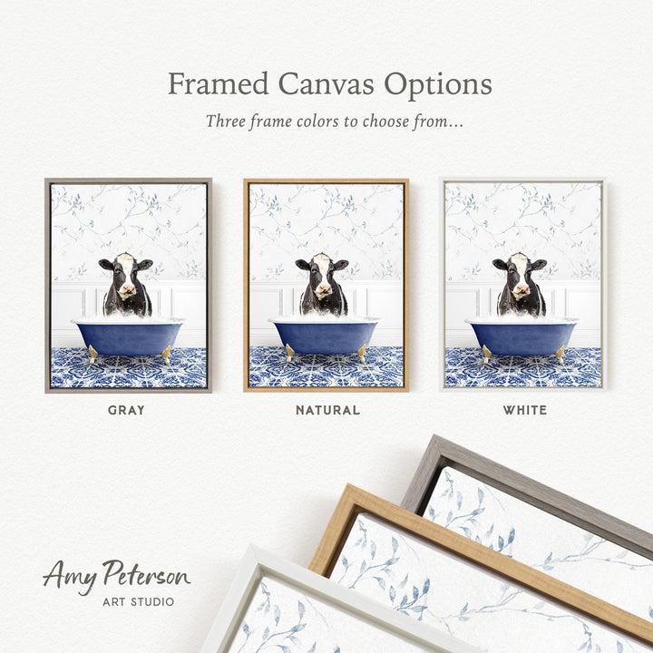 three framed canvas options featuring a cow sitting in a bathtub, each with a different frame color: gray, natural, and white.