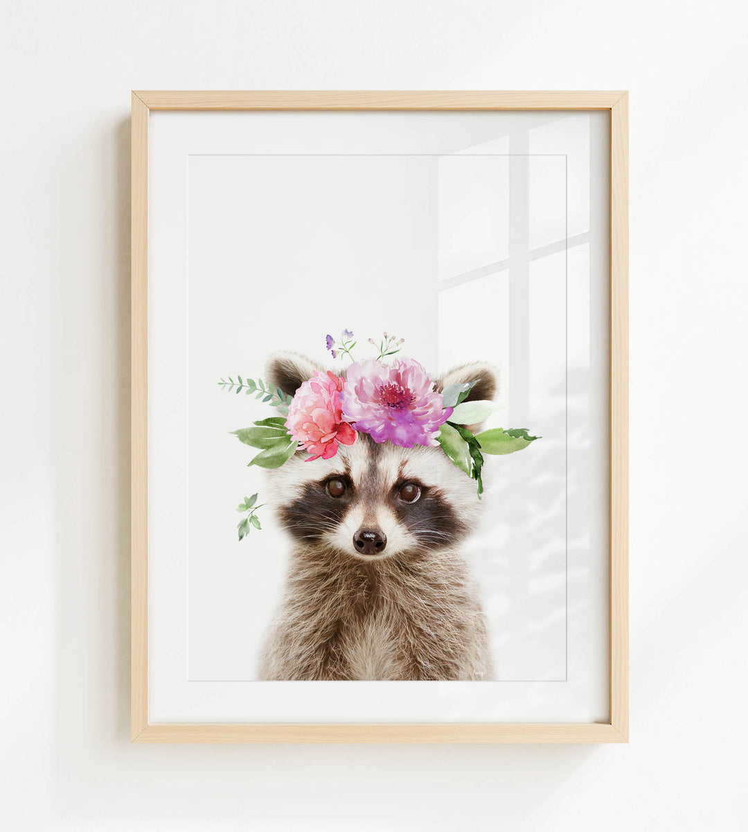 A raccoon wearing a floral crown on its head, with pink and purple flowers and green leaves.