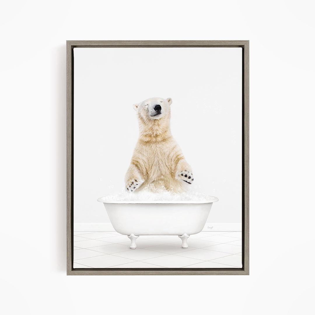 A polar bear is sitting in a white bathtub filled with water, appearing to be enjoying a bath.