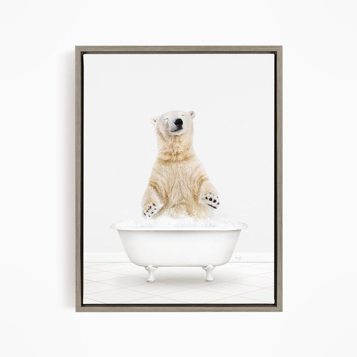 A polar bear is sitting in a white bathtub filled with water, appearing to be enjoying a bath.