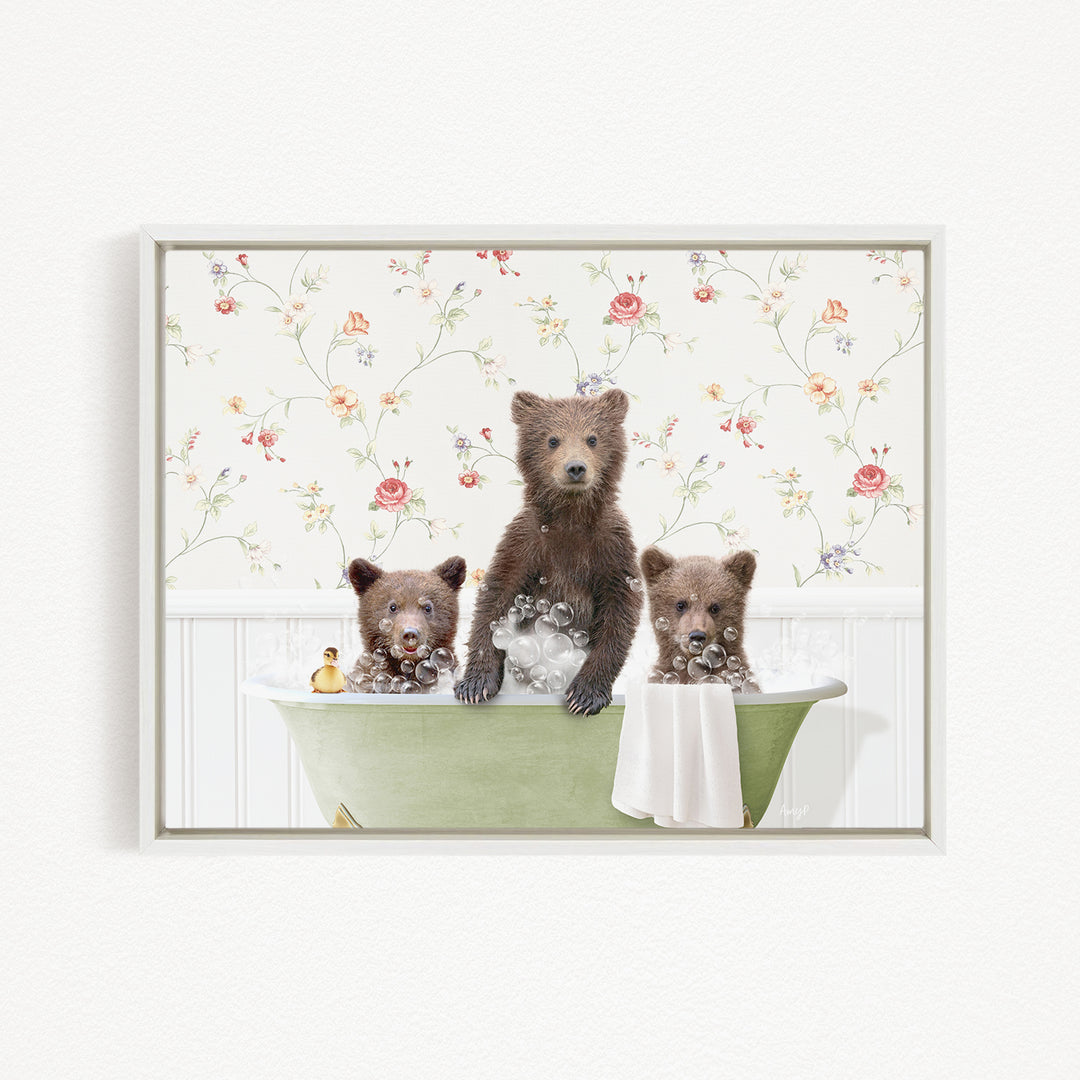 Three adorable brown bears sitting in a green bathtub, surrounded by a floral wallpaper.