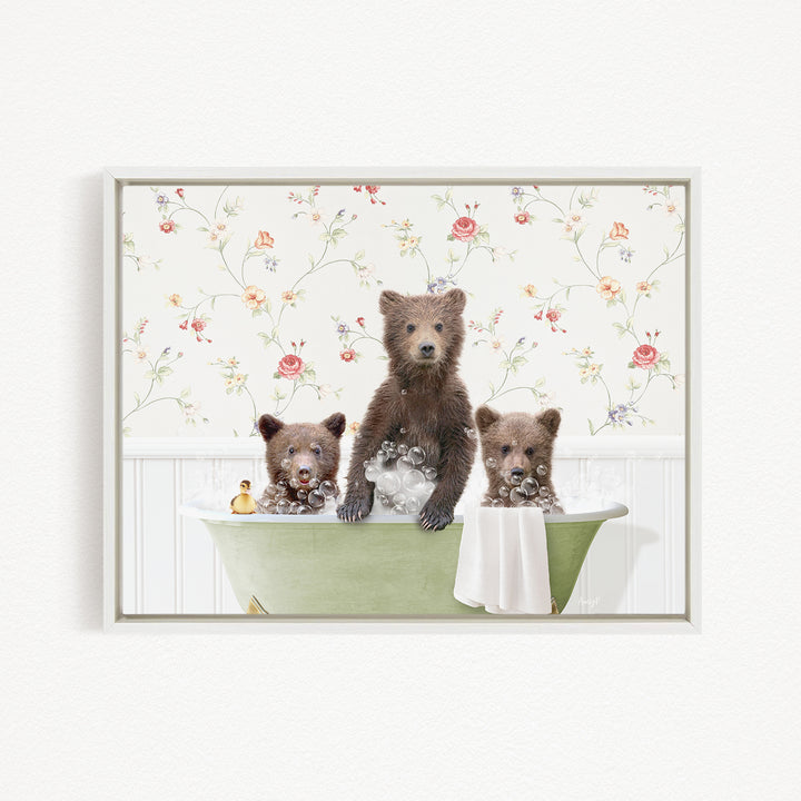 Three adorable brown bears sitting in a green bathtub, surrounded by a floral wallpaper.