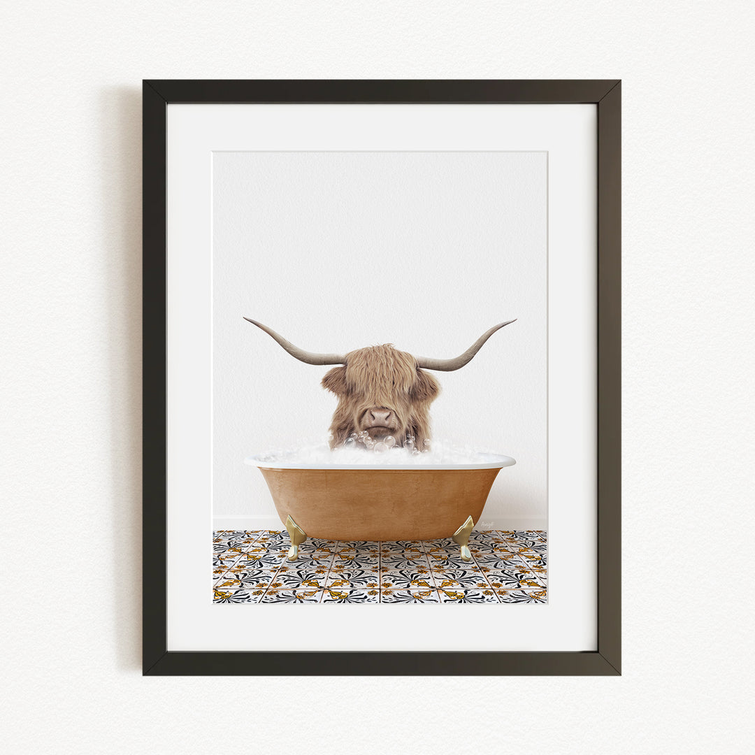 A framed image depicting a horned animal, likely a yak or a similar animal, sitting in a bathtub filled with water.