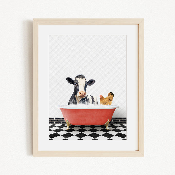 A framed image depicting a cow and a chicken sitting in a red bathtub filled with water, with a black and white checkered floor in the background.
