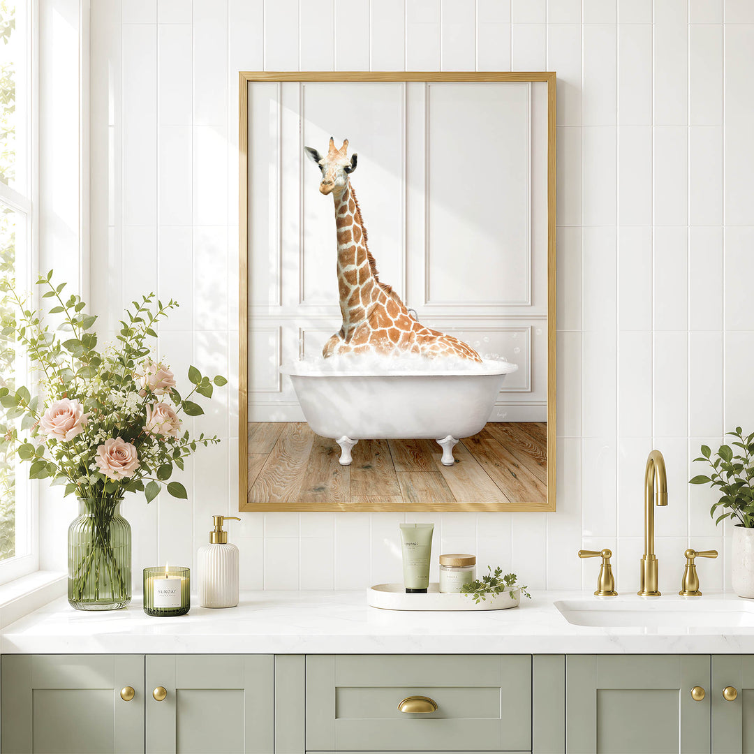 A giraffe sitting in a white bathtub is the central focus of the image, which is framed and displayed on a wall above a bathroom counter.