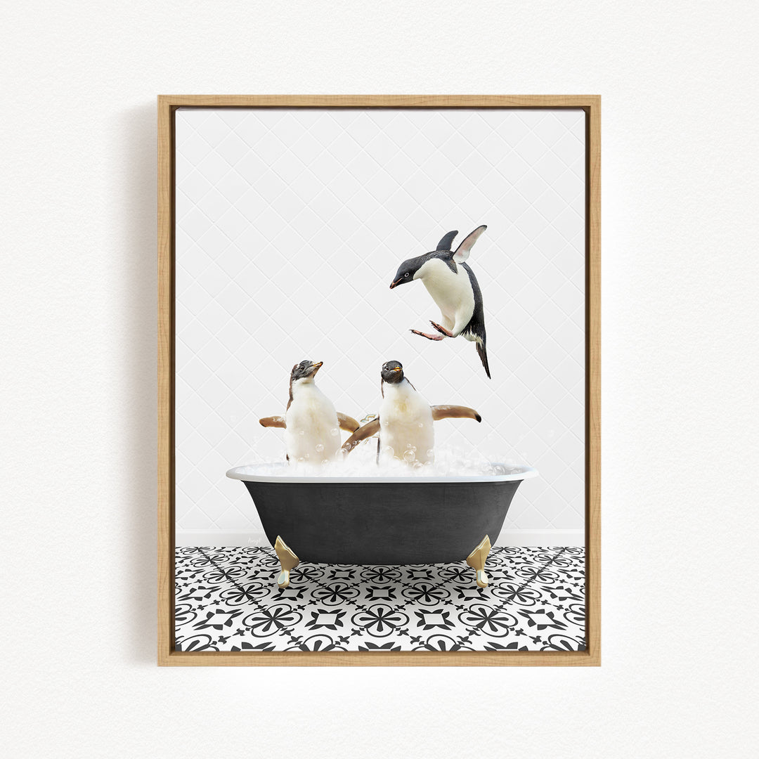 A framed image depicting two penguins sitting in a bathtub, with one penguin jumping out of the tub.