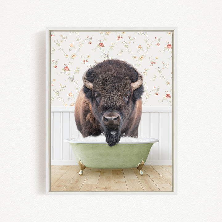 A buffalo with a long beard is sitting in a green bathtub, with a floral wallpaper in the background.