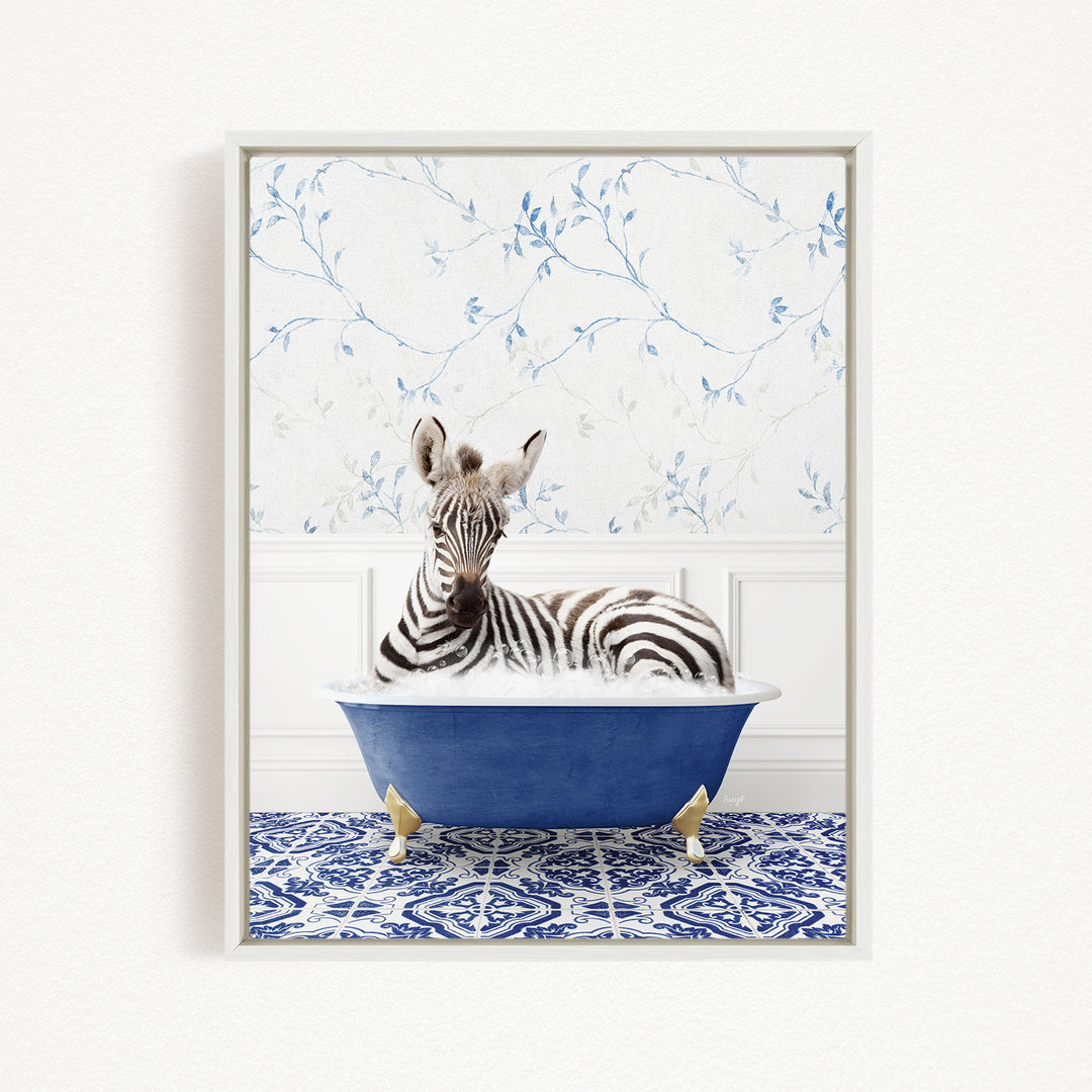 A zebra is sitting in a blue bathtub, surrounded by a blue and white patterned floor and a floral wallpaper background.