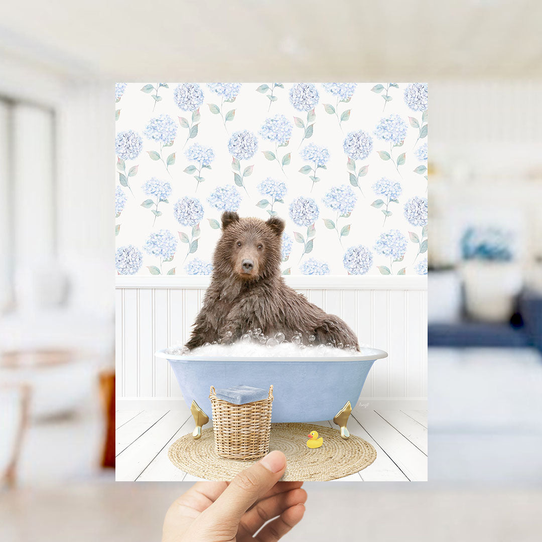 A brown bear sitting in a blue bathtub filled with bubbles, surrounded by a wicker basket and a rubber duck.