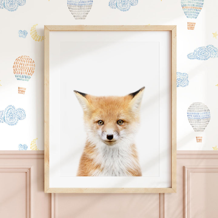 a picture of a fox in a frame on a wall