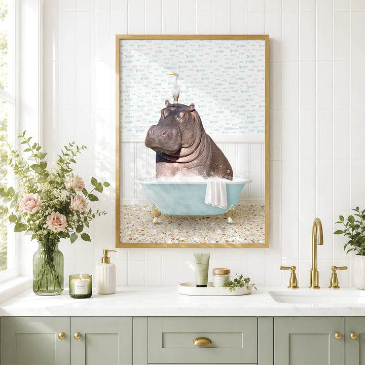 A framed image of a hippopotamus sitting in a bathtub, surrounded by flowers and a vase, is displayed on a wall above a bathroom sink.