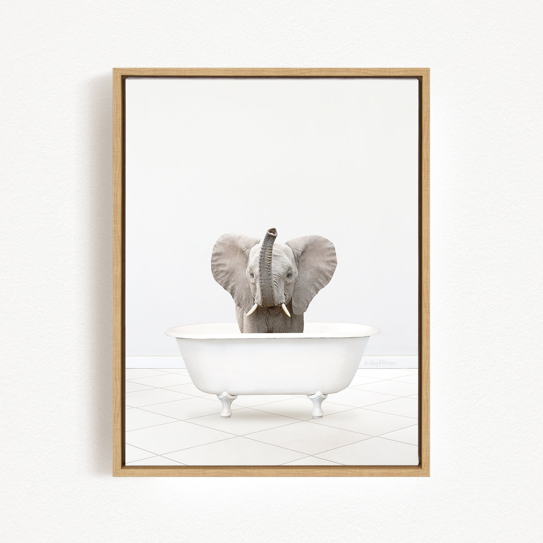 A gray elephant is sitting in a white bathtub, with its trunk raised in the air.