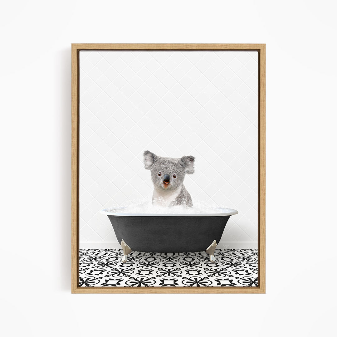 A koala bear sitting in a bathtub filled with water, surrounded by a black and white patterned tile floor.
