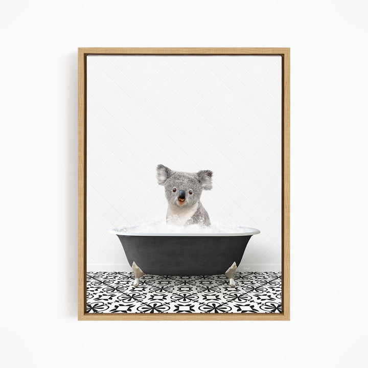 A koala bear sitting in a bathtub filled with water, surrounded by a black and white patterned tile floor.