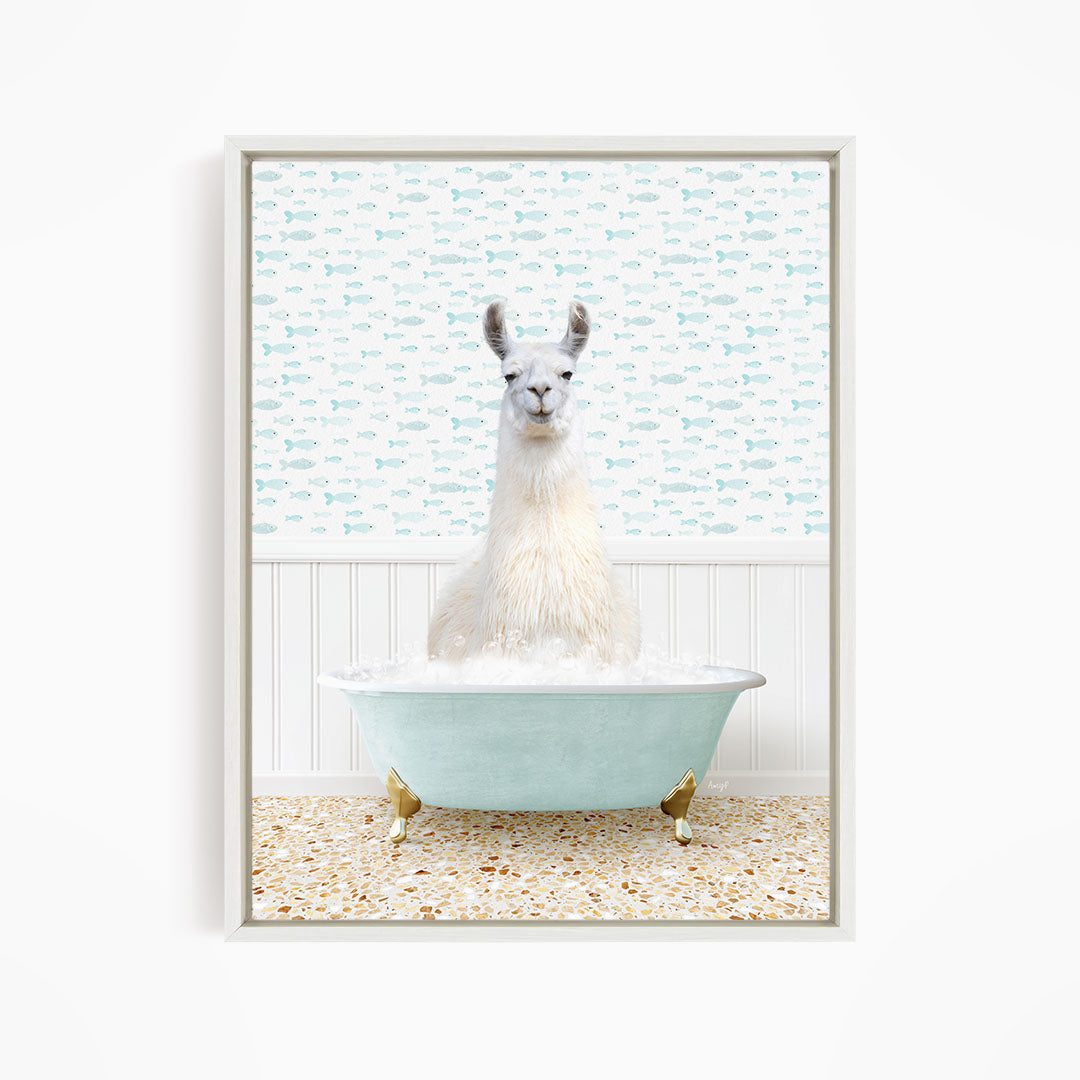 A white llama sitting in a light blue bathtub filled with bubbles, surrounded by a pattern of small fish.
