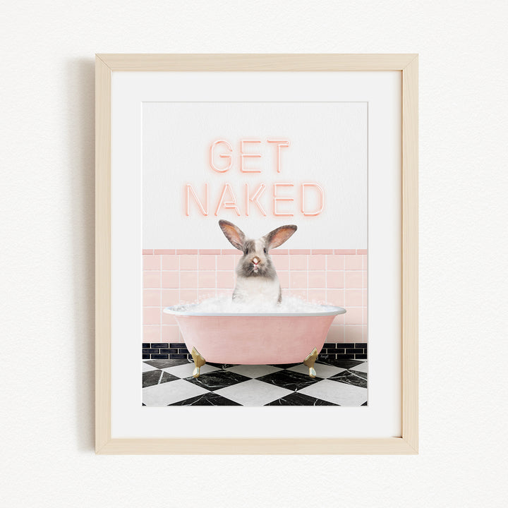 A framed image depicting a rabbit sitting in a pink bathtub filled with bubbles, with the text "GET NAKED" displayed above it.