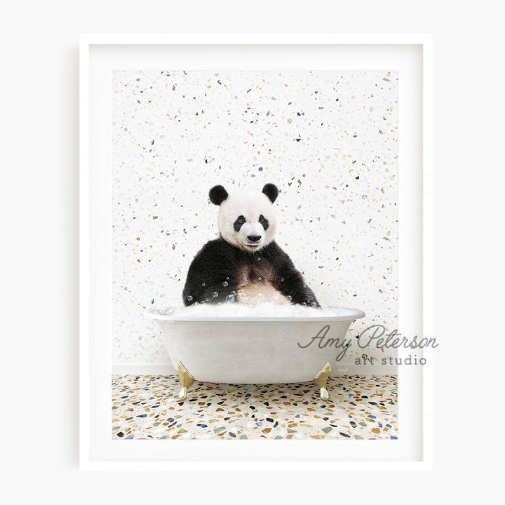 a black and white panda bear sitting in a bathtub