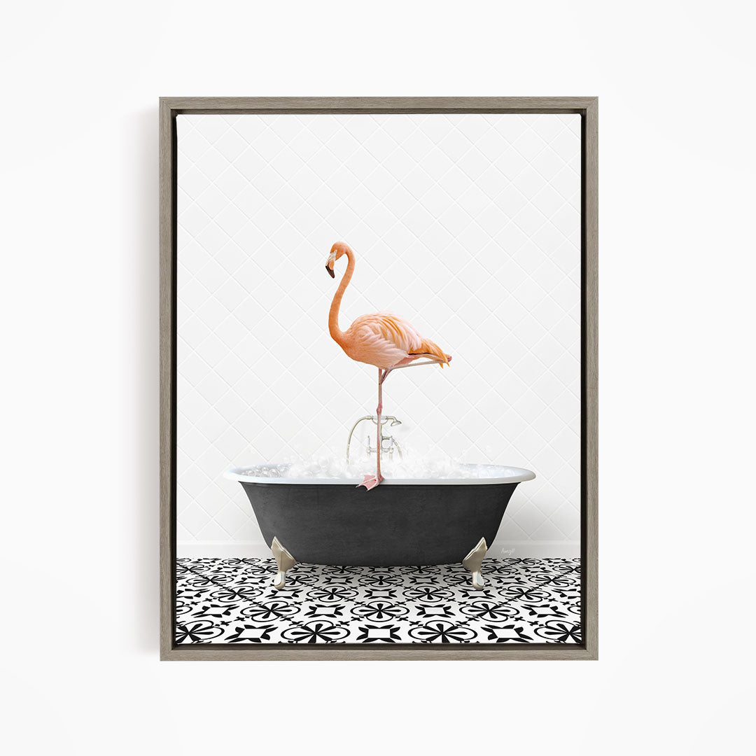 A pink flamingo standing on one leg in a black bathtub filled with water, set against a white background with a black and white patterned floor.