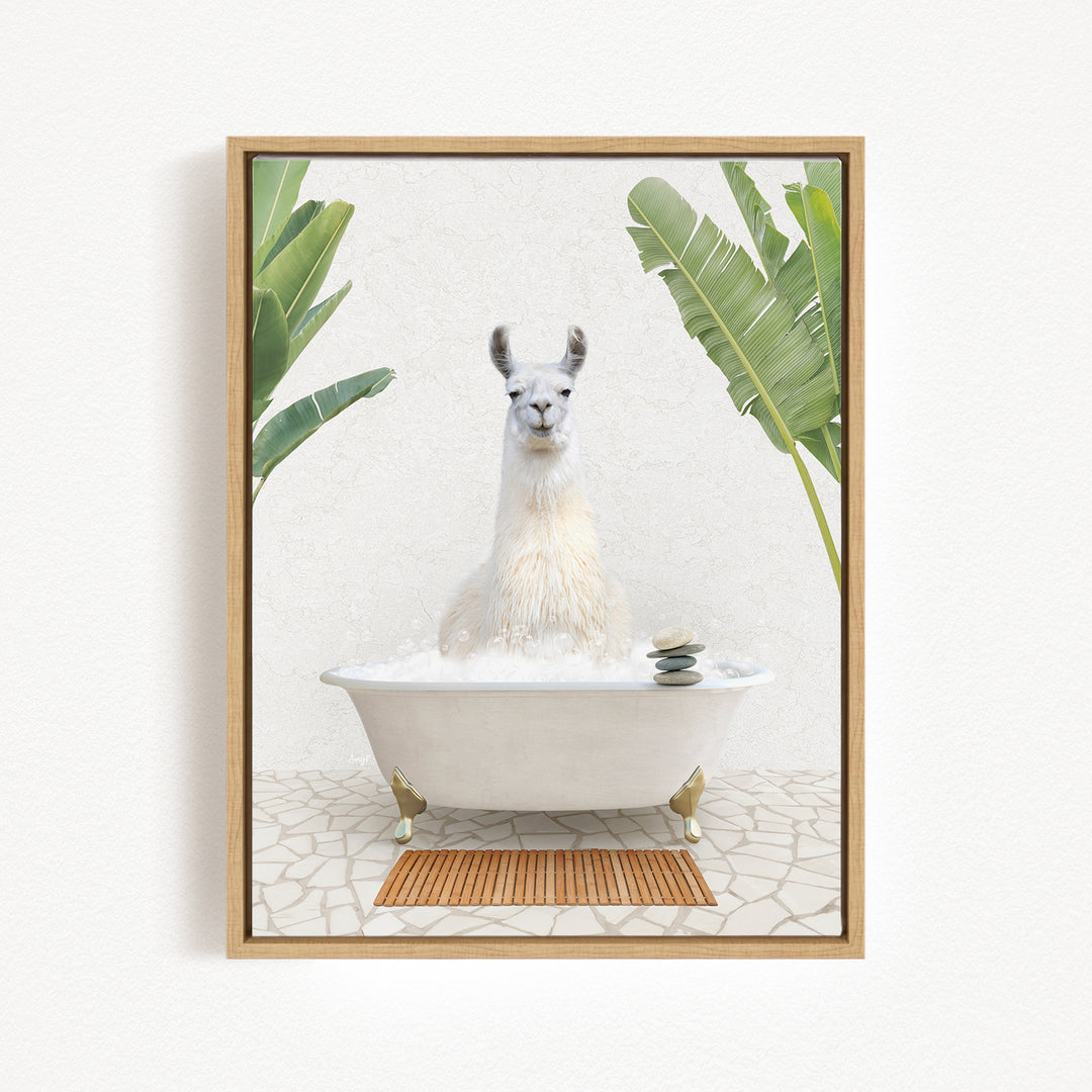 A white llama sitting in a white bathtub filled with bubbles, surrounded by green plants and a wooden mat on the floor.