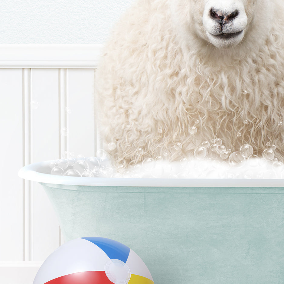 a sheep sitting in a bathtub next to a beach ball