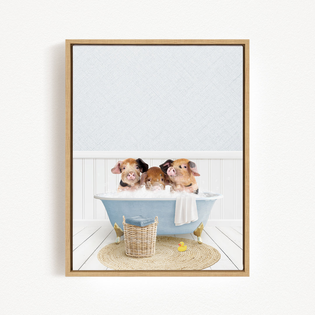 Three adorable pigs sitting in a blue bathtub, surrounded by a yellow rubber duck and a woven basket.