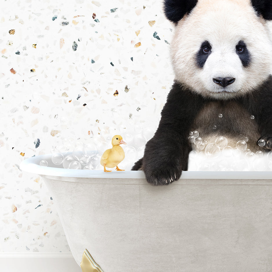 a panda bear sitting in a bathtub with a rubber duck