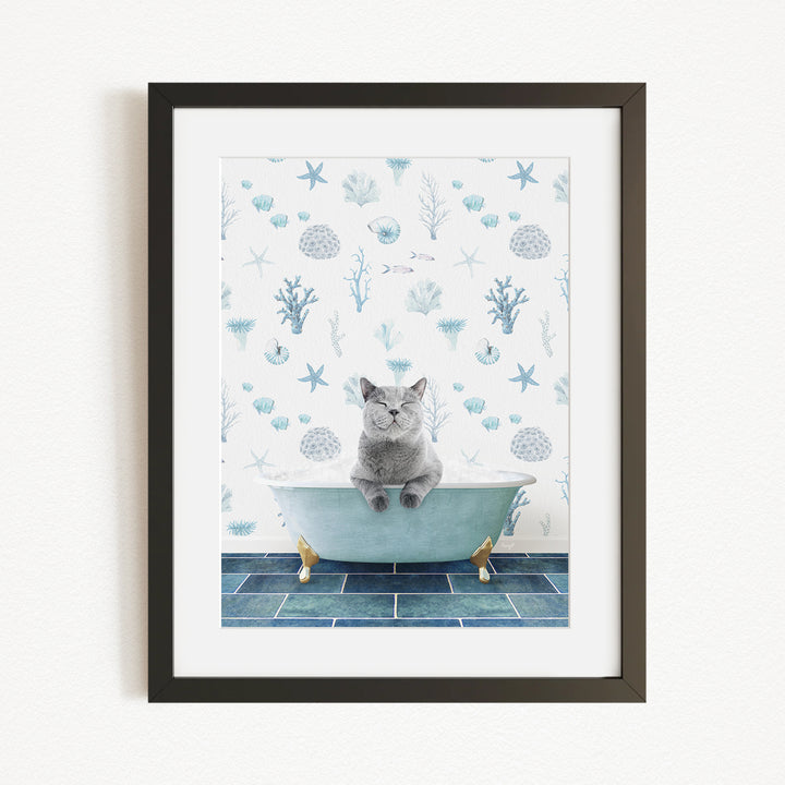 A gray cat sitting in a blue bathtub, surrounded by a pattern of seashells, starfish, and other marine life.