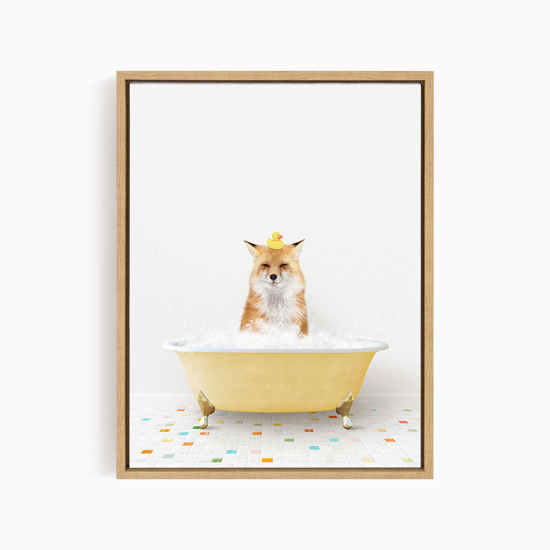 A fox is sitting in a yellow bathtub filled with bubbles, with a rubber duck perched on its head.