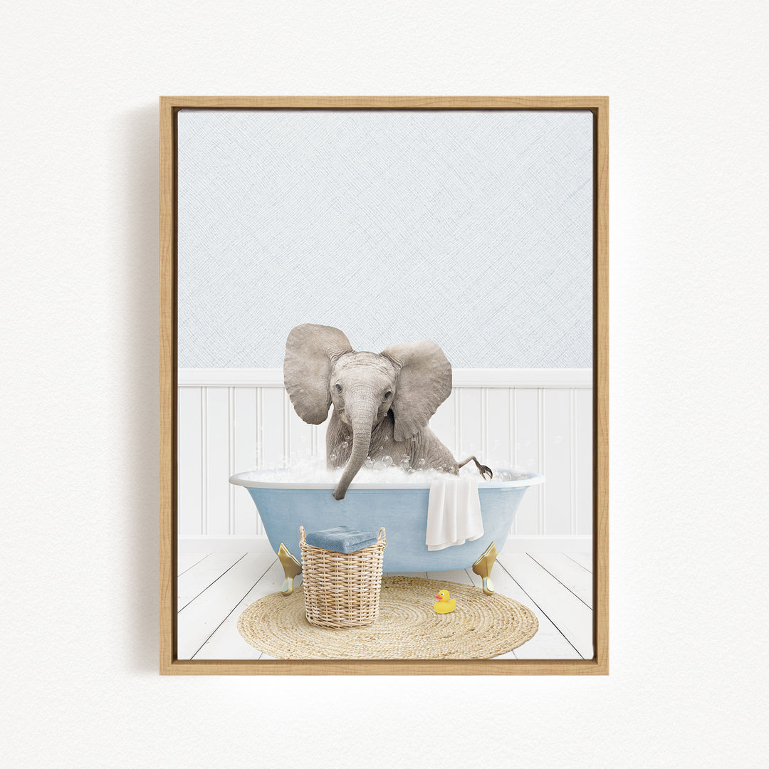 A baby elephant sitting in a blue bathtub filled with water, surrounded by a basket of toys and a yellow rubber duck.