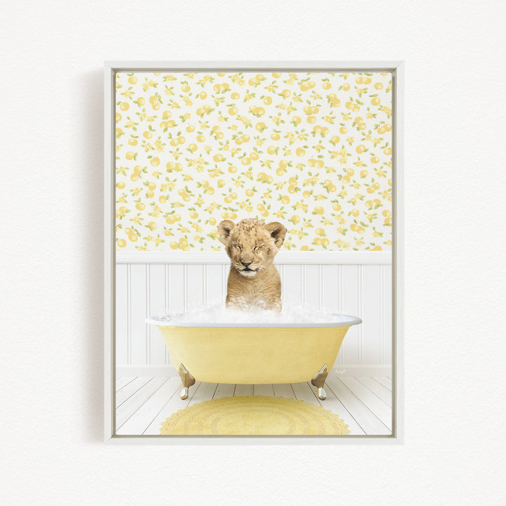 A young lion cub is sitting in a yellow bathtub filled with water, surrounded by a yellow floral wallpaper.