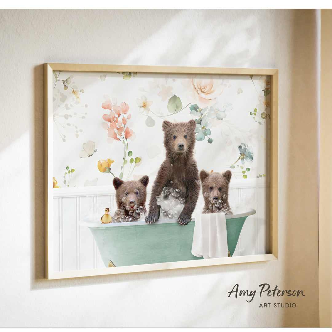 A framed print of three bears sitting in a bathtub, with one bear sitting in the center and the other two bears sitting on either side.