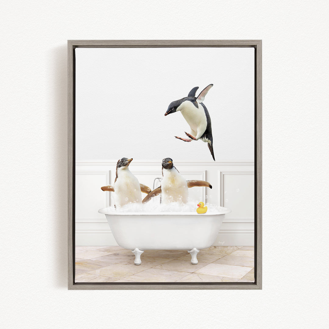 A framed image depicting two penguins sitting in a bathtub, with one penguin jumping out of the tub and another penguin sitting in the tub.