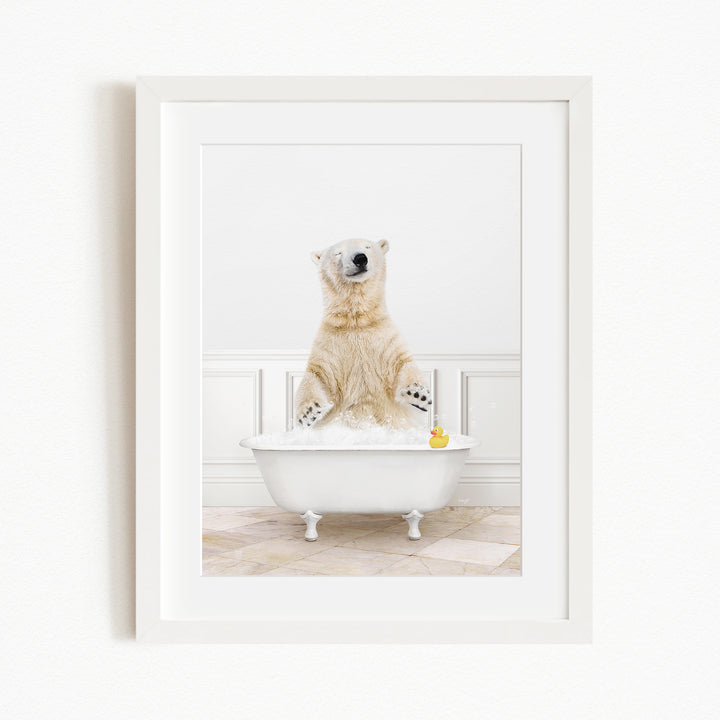 A polar bear is sitting in a white bathtub filled with water, surrounded by a yellow rubber duck.