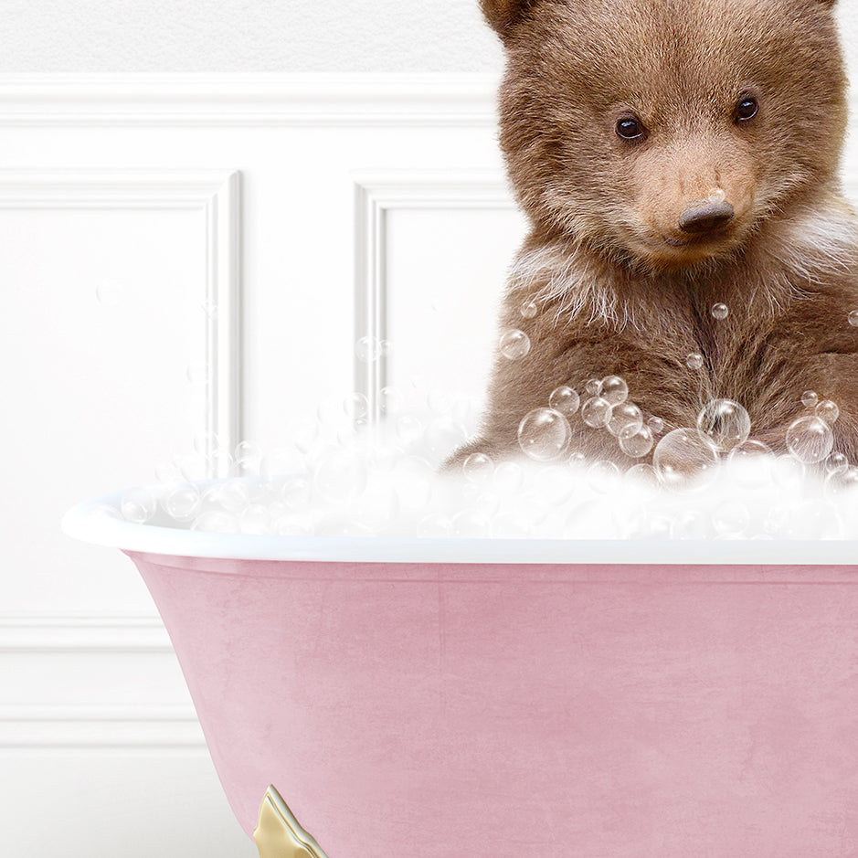 a brown bear sitting in a bath tub filled with bubbles