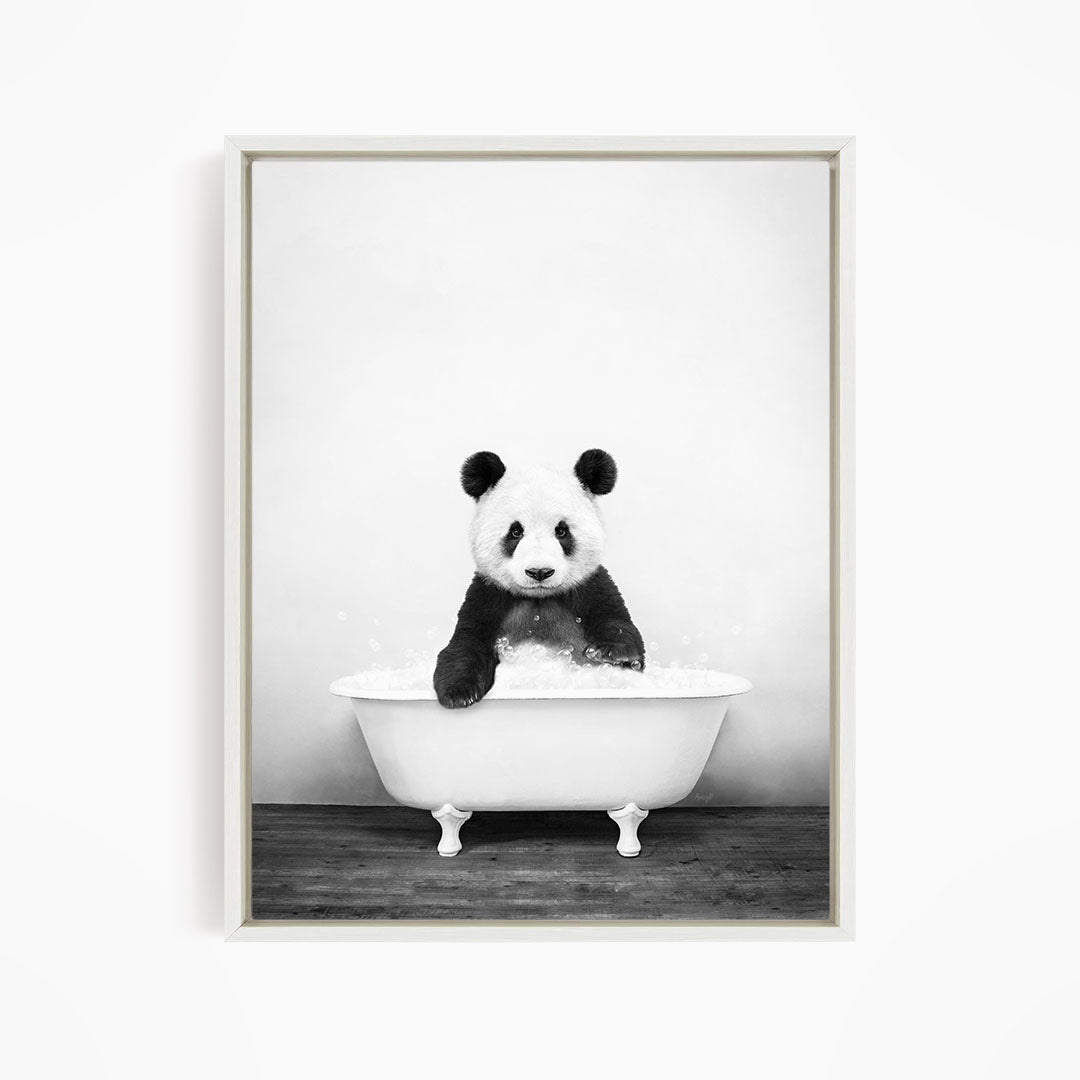 A panda bear sitting in a white bathtub filled with bubbles, creating a whimsical and playful scene.